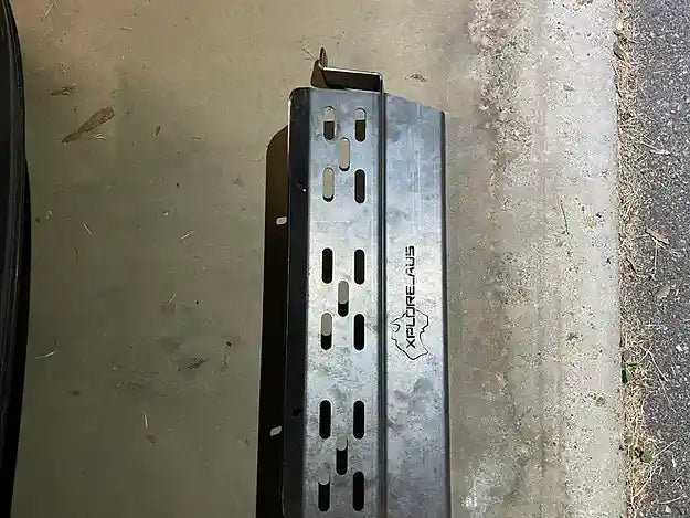 Metal Radiator Protector with 'xploreaus' branding on a concrete surface