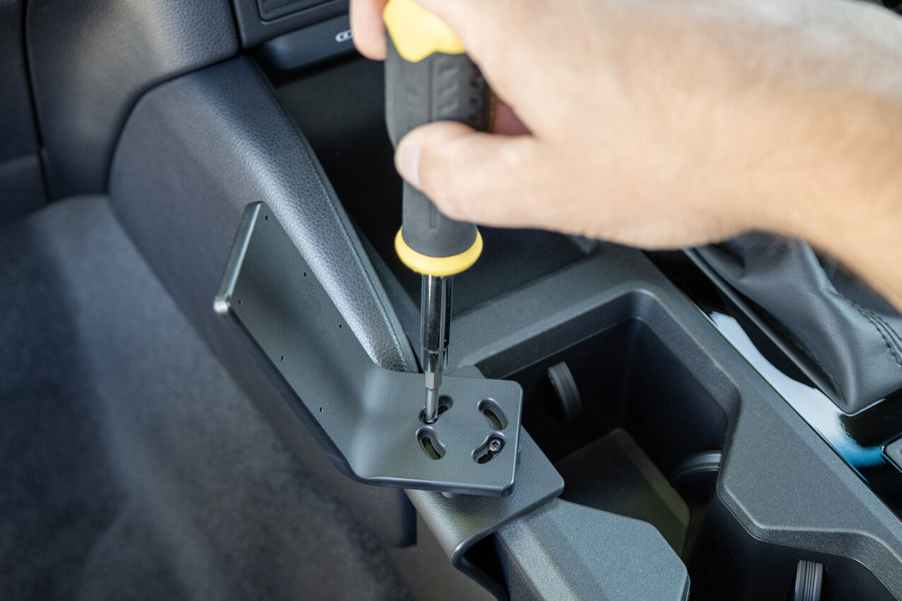 Person using a screwdriver to install ClicOn Dash Mount