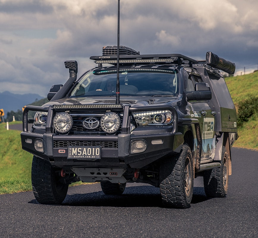 Toyota vehicle on a road with mountains in the background
