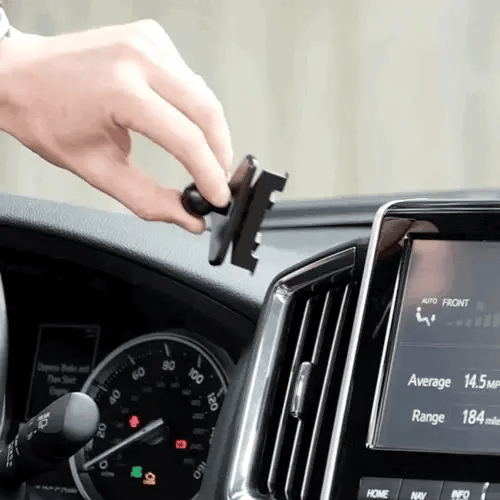 Person installing a phone mount on a car dashboard