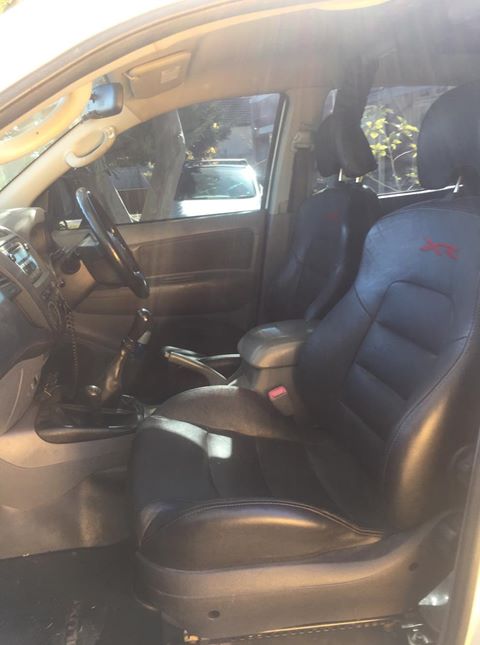 Car interior with black racing seats and steering wheel.