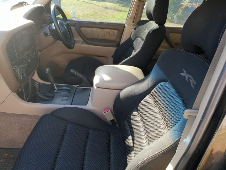 Car interior with black and gray seats, steering wheel, and dashboard.