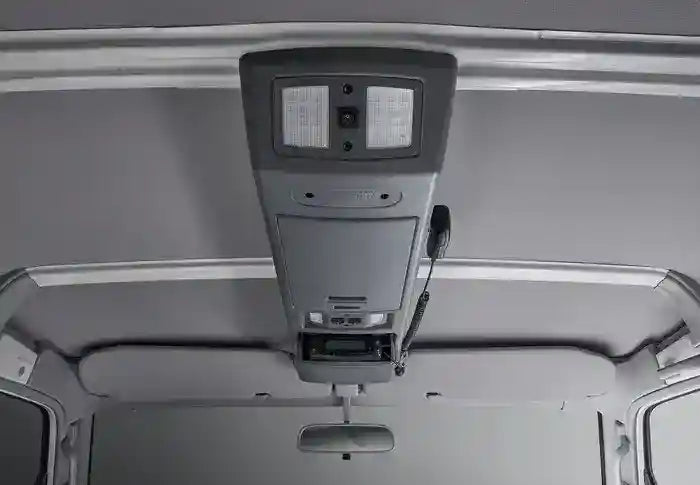 Overhead console in a vehicle with multiple compartments and controls.