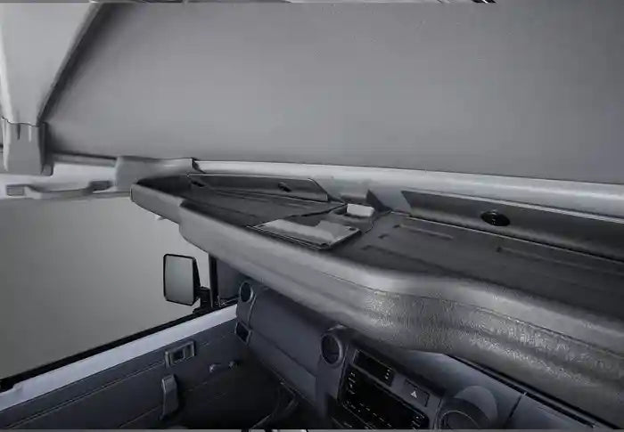 Gray interior of a vehicle with Top Shelf and side mirror