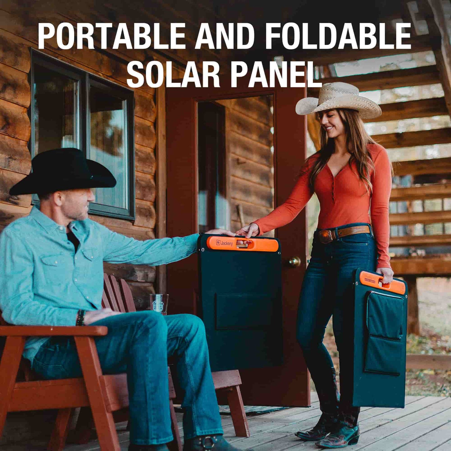 Man and woman with portable foldable solar panels in front of a wooden cabin.