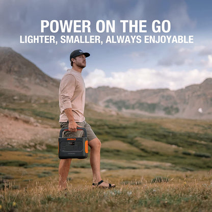 Man holding a portable power station in a mountainous landscape with text 'Power on the Go'.