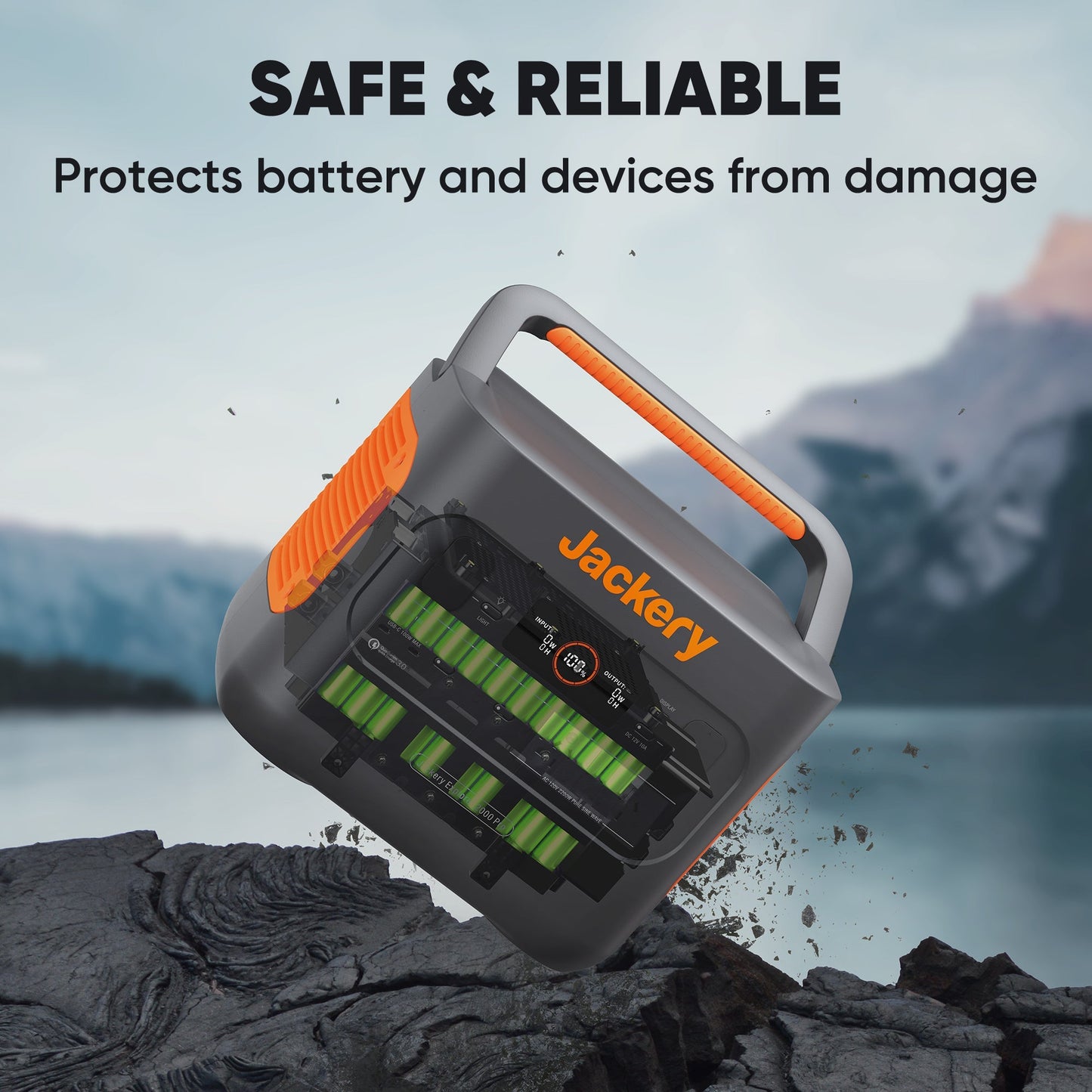 Jackery battery protector device on a rocky surface with mountain background
