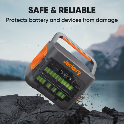 Jackery battery protector device on a rocky surface with mountain background