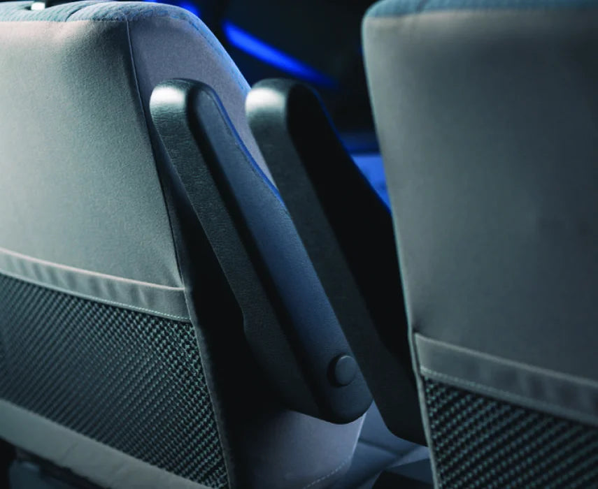 Close-up of car seats with a focus on the armrest area.