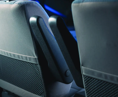 Close-up of car seats with a focus on the armrest area.