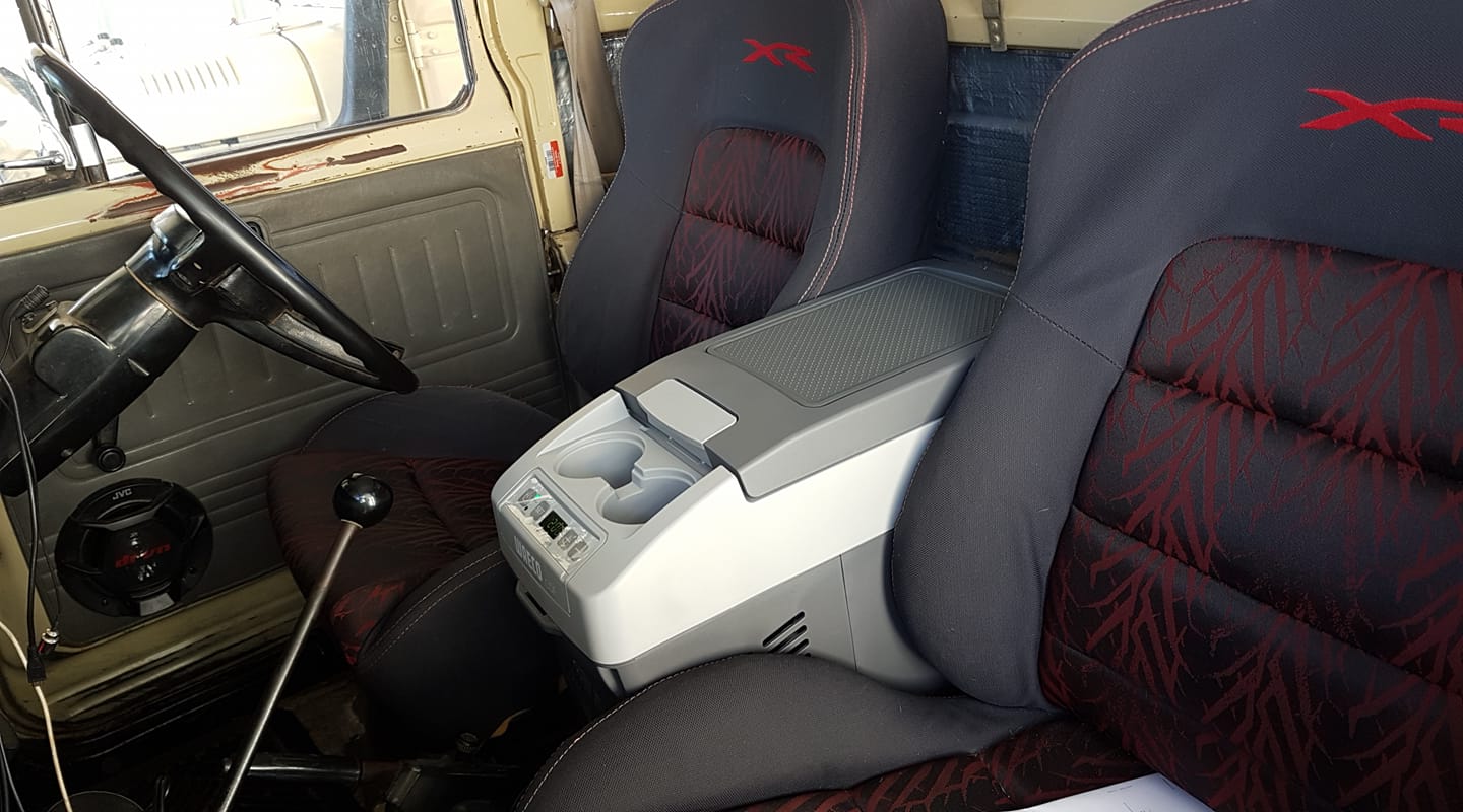 Car interior with gray and red seats and a visible gear shift.