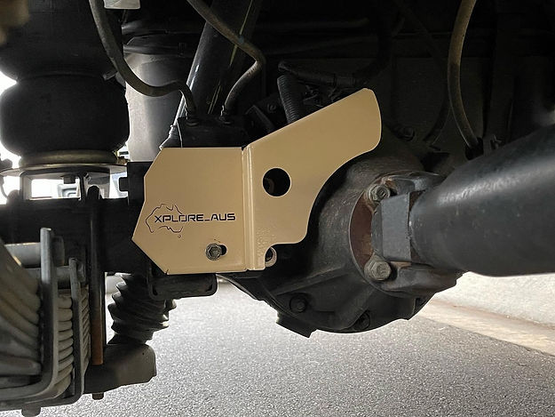 Close-up of a gold Diff Lock Protector with 'Xplor-Aus' branding on a vehicle's undercarriage.