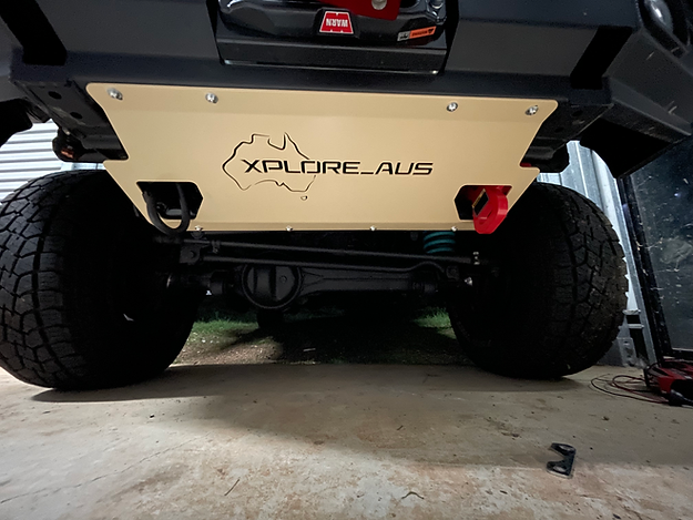 Front end of a vehicle with 'Xplore Aus' branding on a concrete surface.