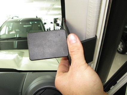 Hand holding a ClicOn Dash Mount 