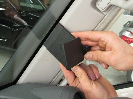 Person installing a ClicOn Dash Mount 