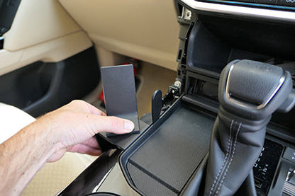 Hand placing a ClicOn Dash Mount 