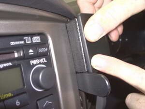 Close-up of a device with a power/volume knob and a person's hand interacting with it.