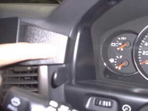Close-up of a car dashboard with speedometer and other controls.