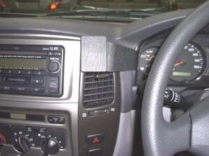 Car interior with dashboard, steering wheel, and control panels.