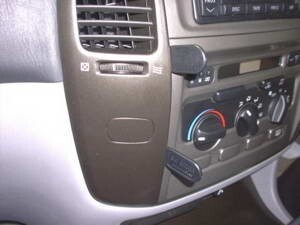 Car dashboard with air conditioning controls and steering wheel