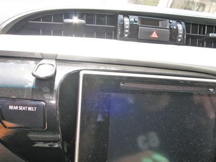 Car interior with dashboard and air conditioning controls visible