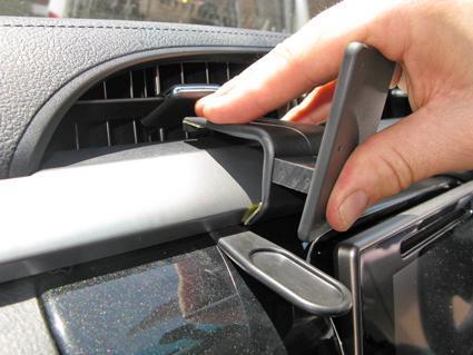Hand placing a ClicOn Dash Mount