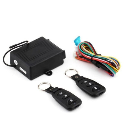 Car alarm system with black control box, two key fobs, and wiring harness on a white background