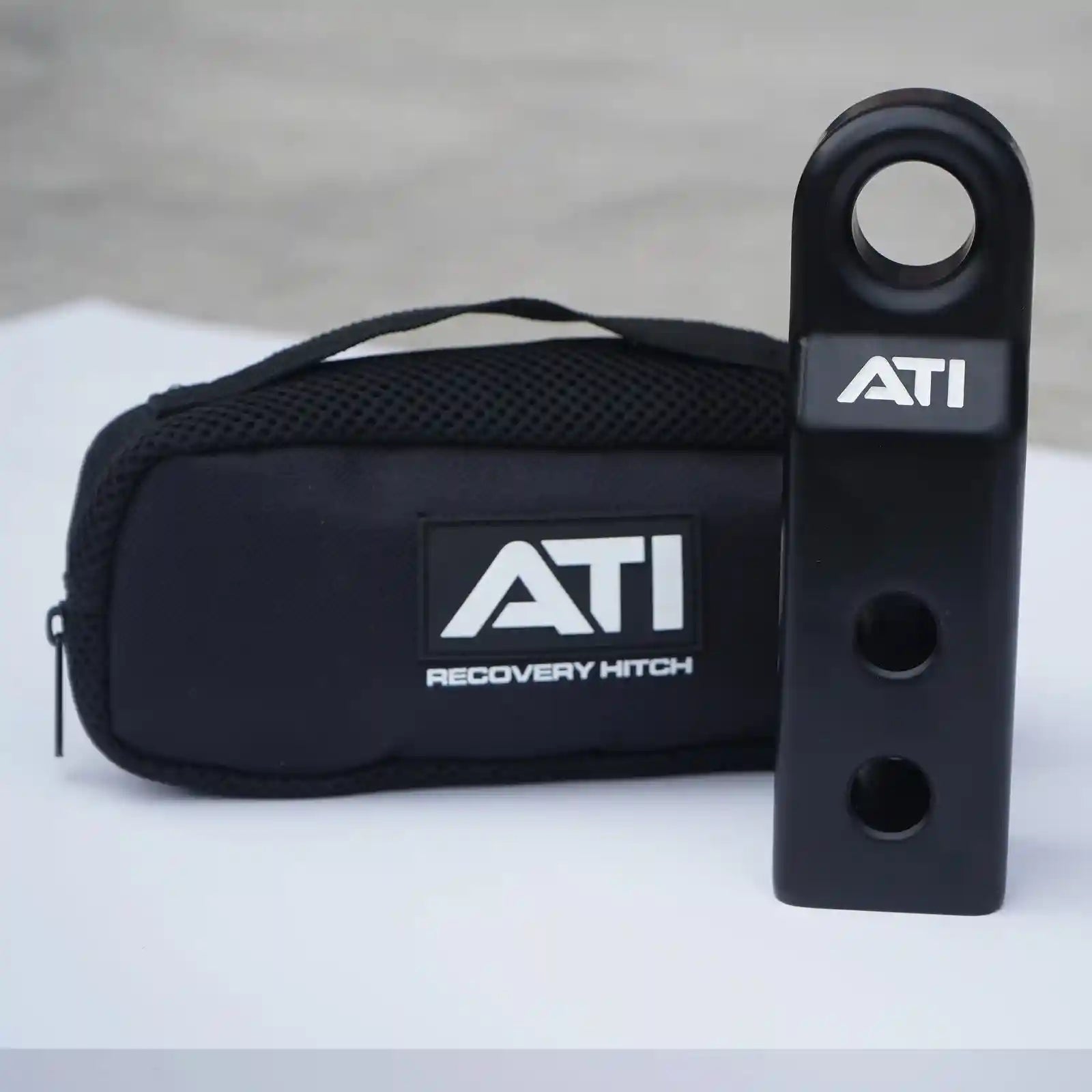 ATI recovery hitch and carrying case on a light gray background