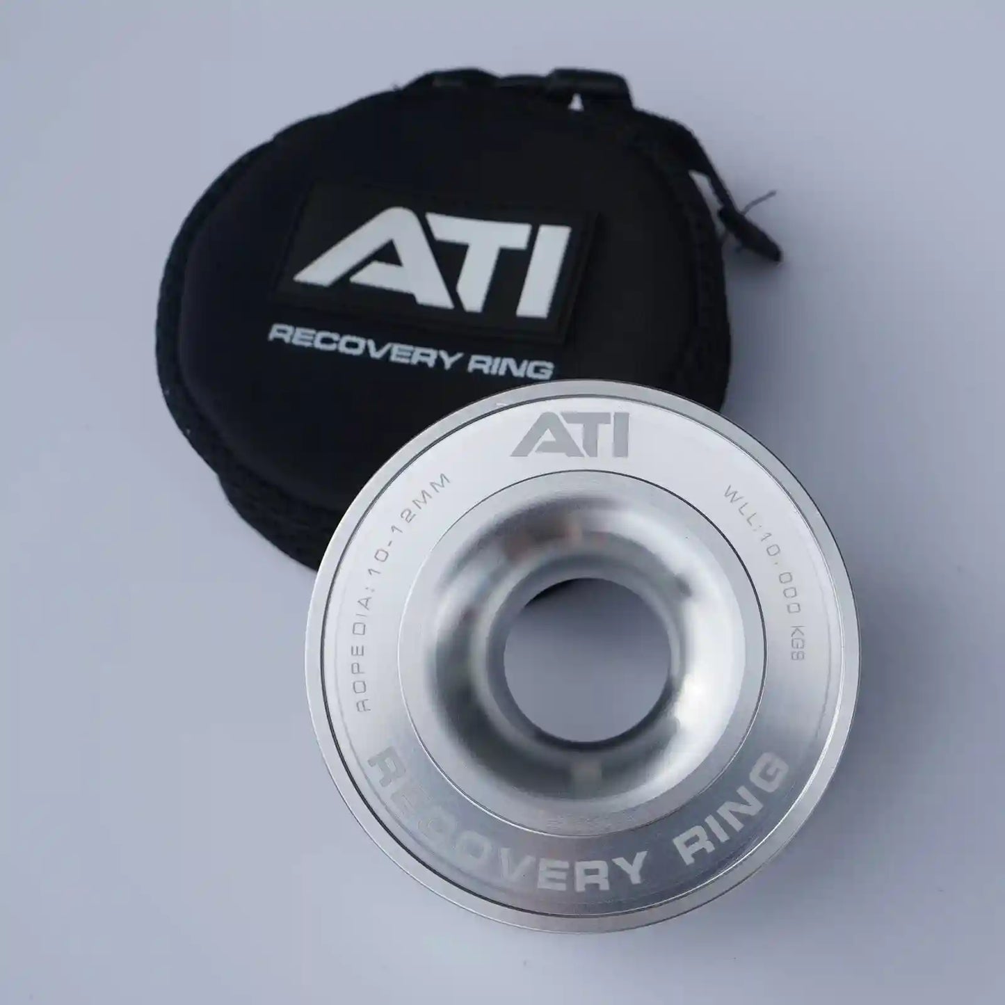 Silver ATI Recovery Ring with black pouch on a light gray background