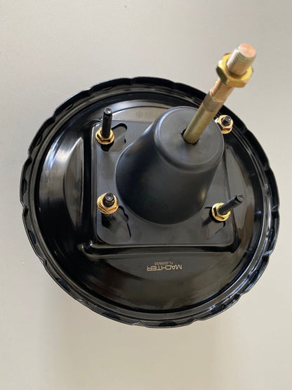 Black Power Brake Booster with gold bolts on a light gray background