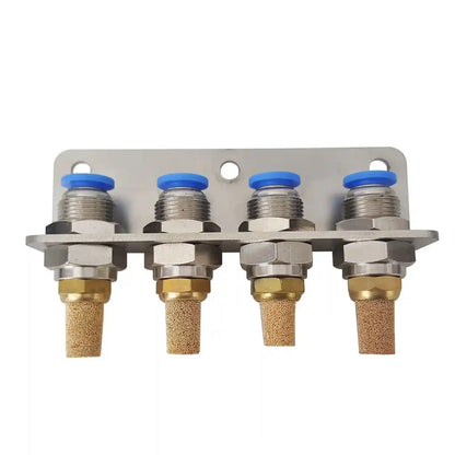 Metal valve manifold with four brass nozzles and blue caps on a white background