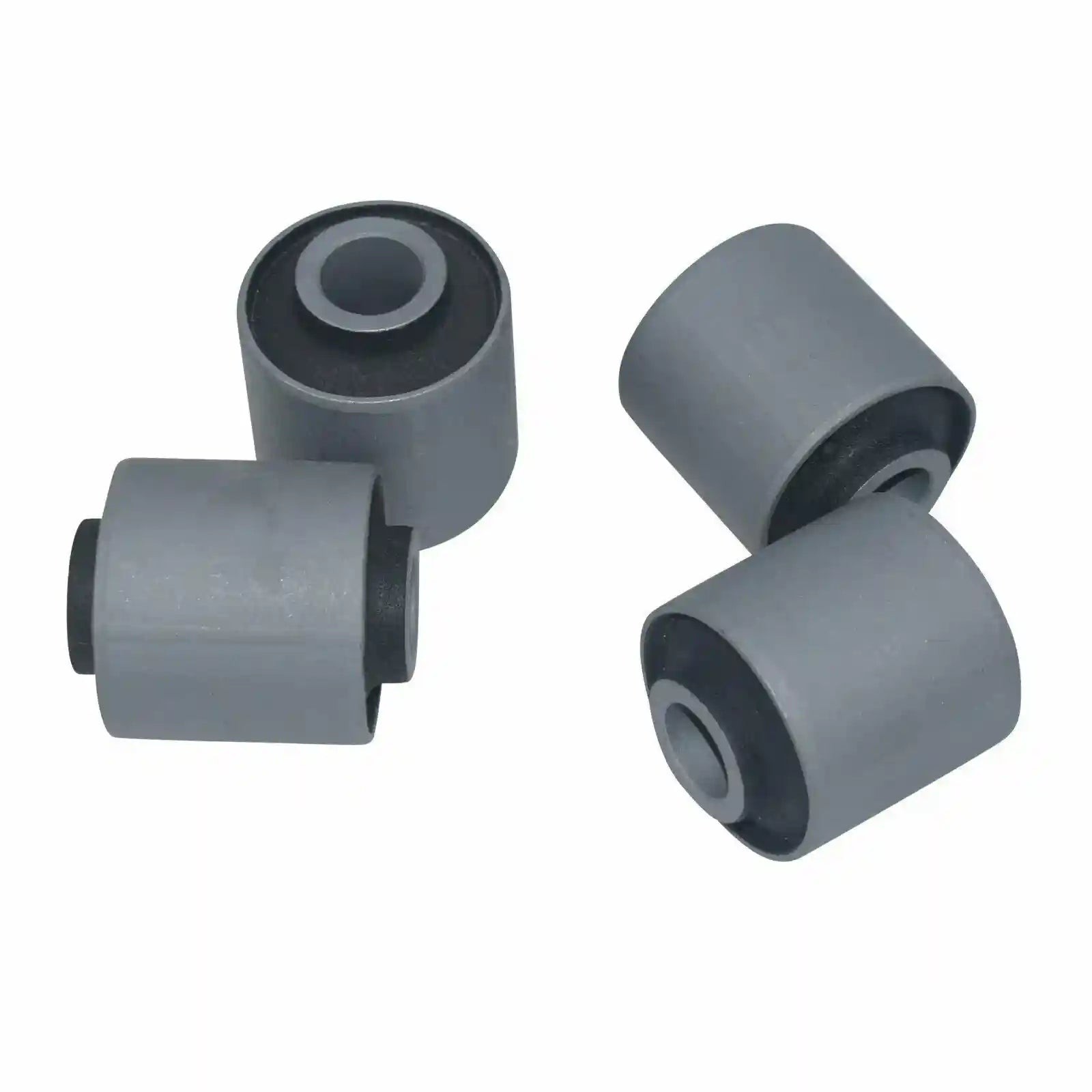 Four gray rubber bushings on a white background