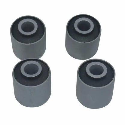 Four gray rubber bushings on a white background