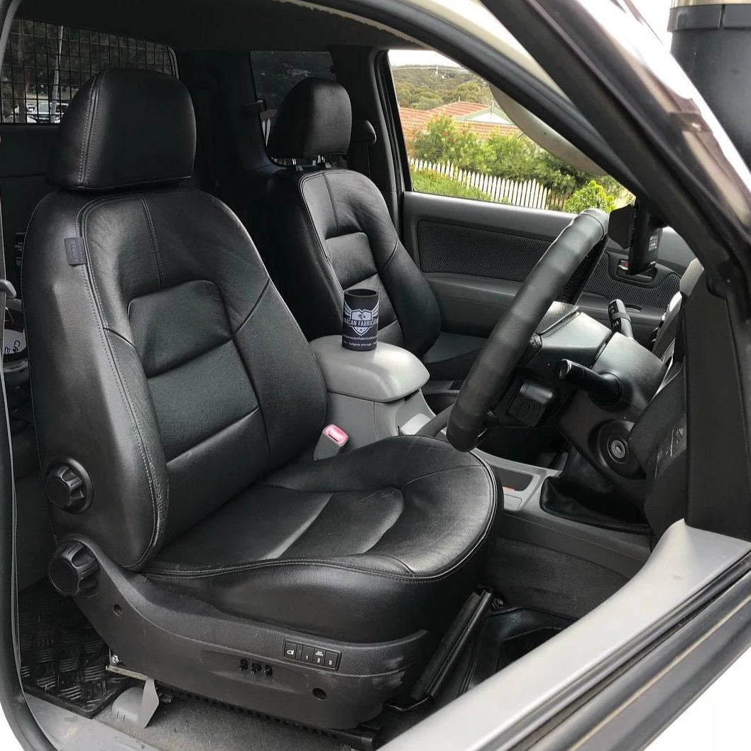 Car interior with black leather seats and steering wheel.