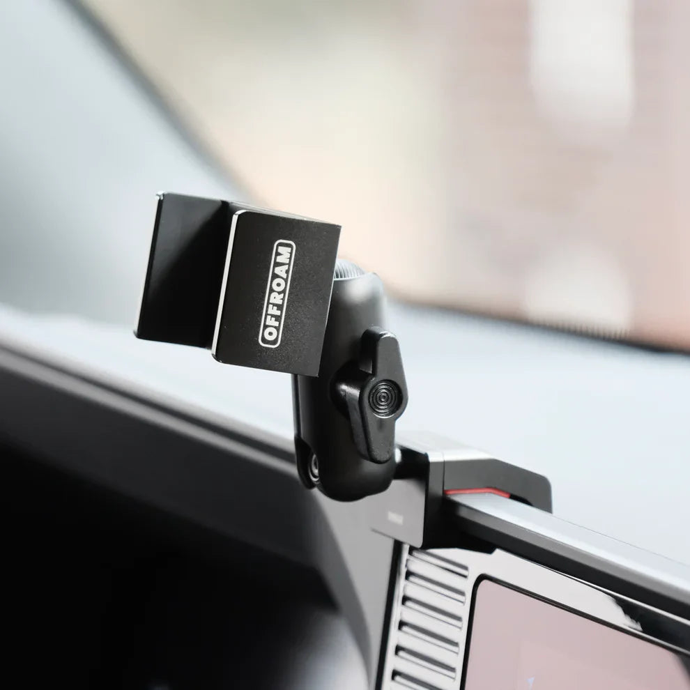 Car visor with a mounted phone holder labeled 'OFFROAD' on a vehicle interior.