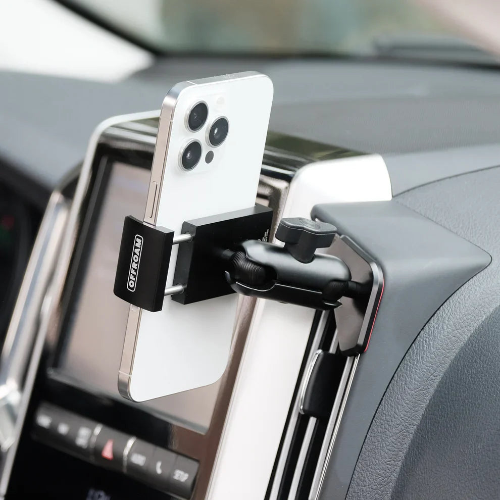 Phone holder on a car dashboard with a smartphone attached, branded 'OFFROAM'.
