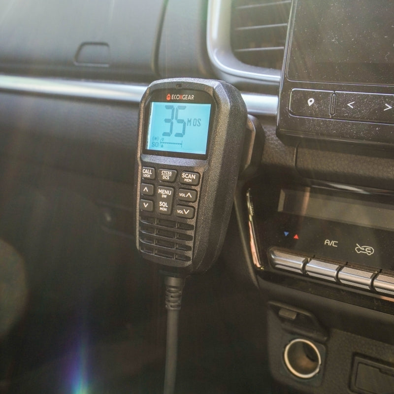 Radio in a car dashboard with digital display showing '35'.