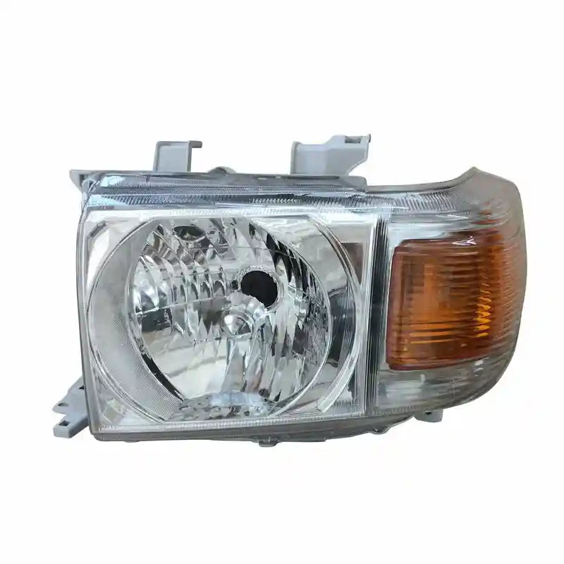 Car headlight assembly with clear lens and orange indicator on a white background