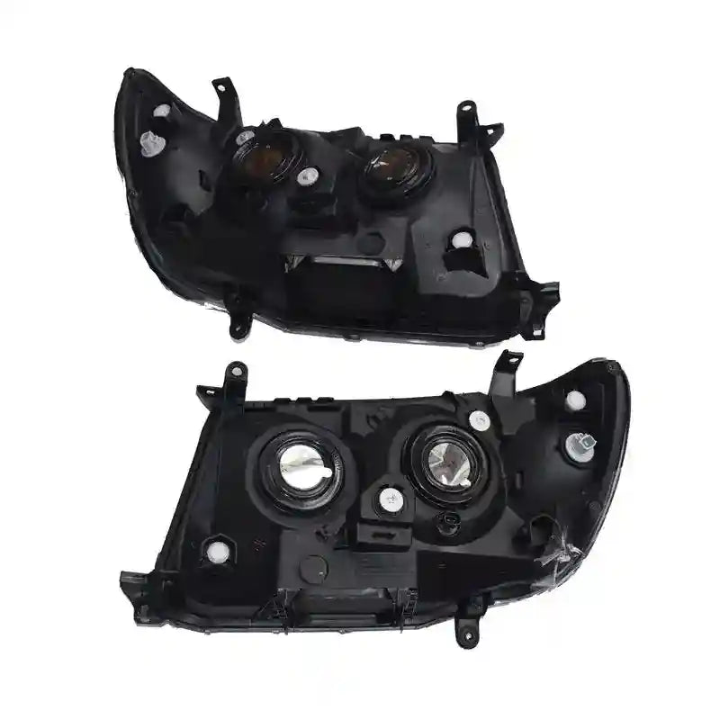 Two black car headlight assemblies on a white background