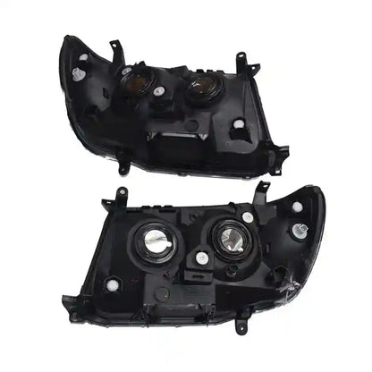 Two black car headlight assemblies on a white background