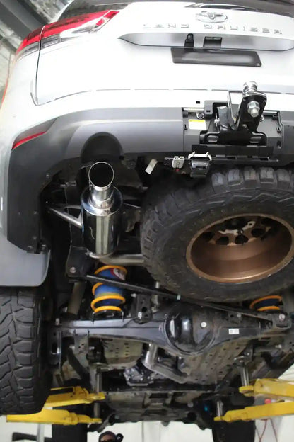 Close-up of a Land Cruiser vehicle with lifted suspension and off-road tires.