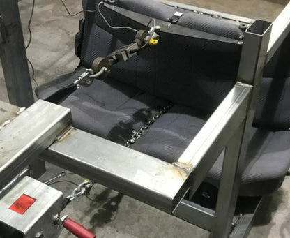 Mechanical device with a seat and chains on a concrete floor