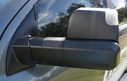 Side view mirror of a vehicle with a visible brand logo.