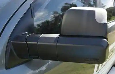 Side view mirror of a vehicle with a visible brand logo.