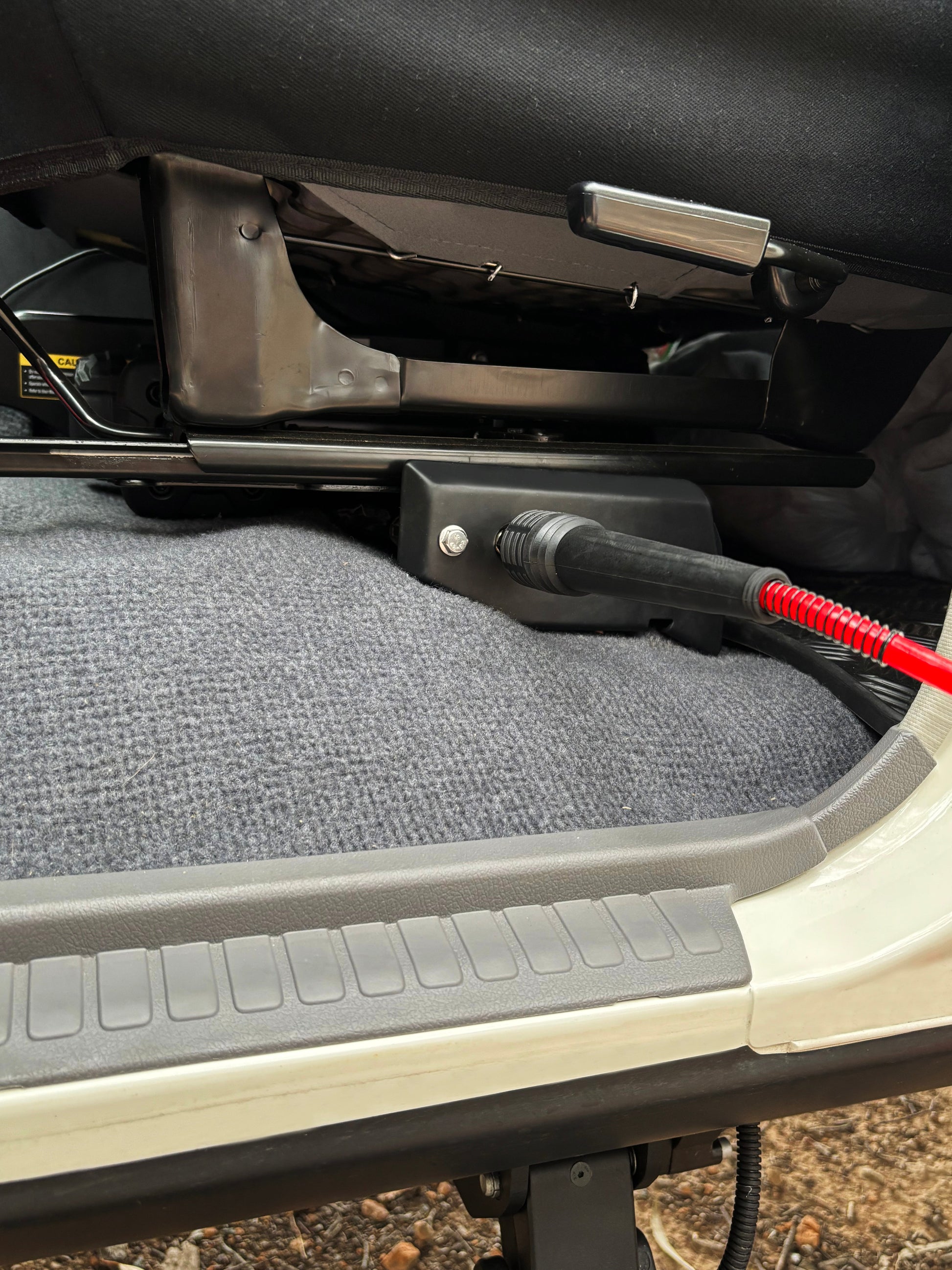 Car seat and tire pressure hose attached, showing a close-up of the interior.