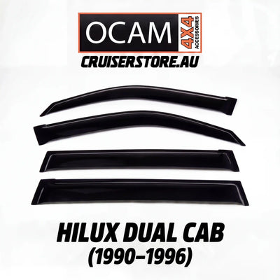 Set of black window deflectors for Hilux Dual Cab with OCAM 4x4 Accessories branding on a white background.