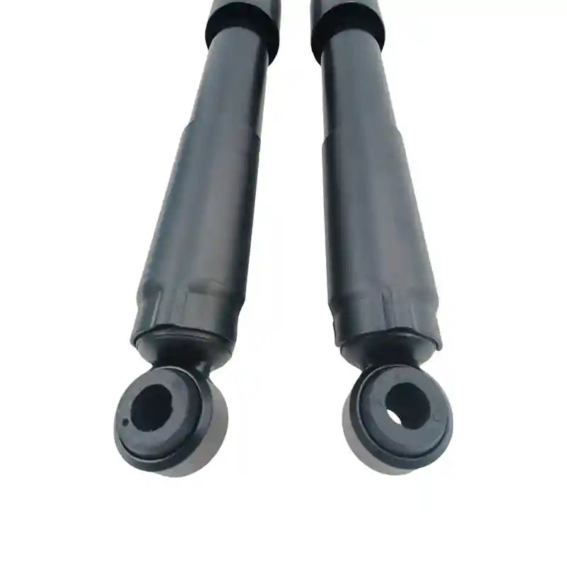Two black shock absorbers on a white background