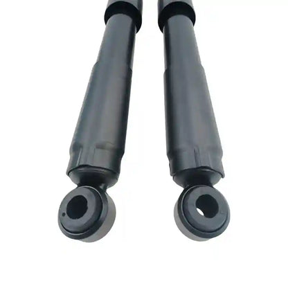 Two black shock absorbers on a white background