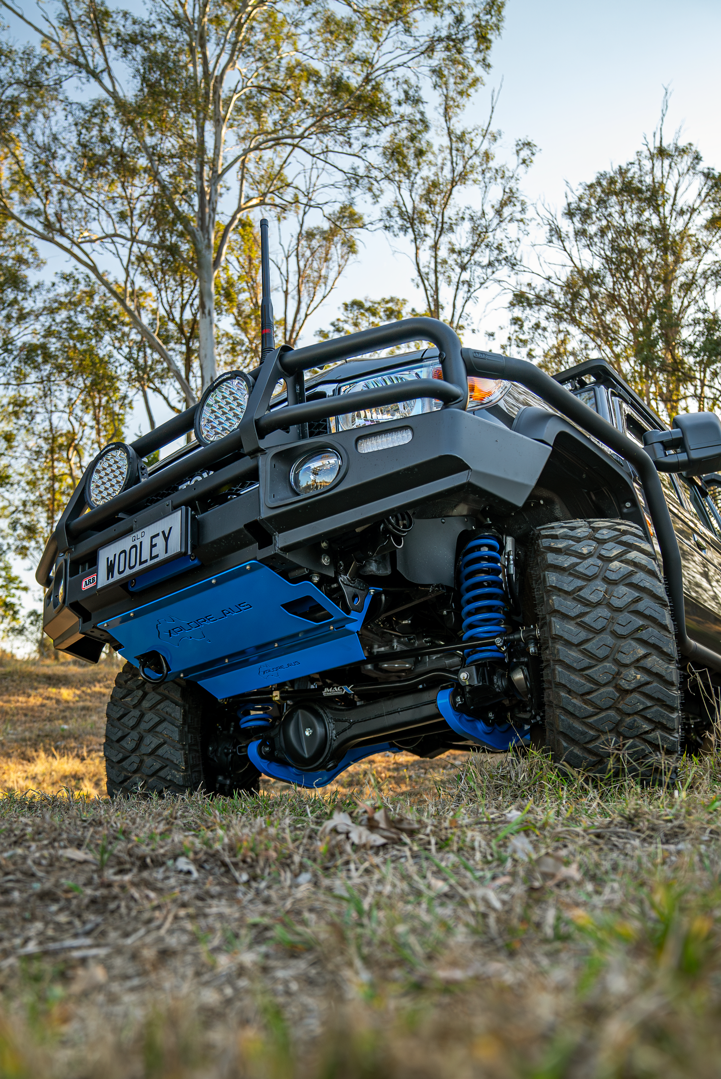 Off-road vehicle with blue Radiator Protector in a natural setting