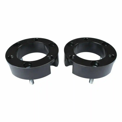 Two black Coil Strut Shock spacers on a white background